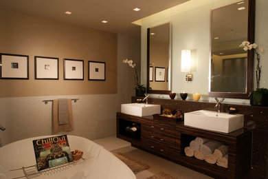Mid-sized asian master brown tile and stone slab ceramic tile and beige floor bathroom photo in Kansas City with flat-panel cabinets, dark wood cabinets, a one-piece toilet, beige walls, a pedestal sink and solid surface countertops