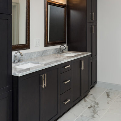 Inspiration for a mid-sized transitional master gray tile and porcelain tile marble floor bathroom remodel in Atlanta with shaker cabinets, dark wood cabinets, a one-piece toilet, white walls, an undermount sink and granite countertops