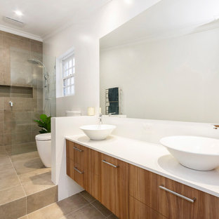 Design ideas for a contemporary 3/4 bathroom in Perth with flat-panel cabinets, medium wood cabinets, an alcove shower, a one-piece toilet, beige tile, white walls, a vessel sink, beige floor, an open shower and white benchtops.
