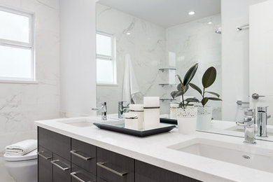 Design ideas for a contemporary shower room bathroom in Vancouver with flat-panel cabinets, dark wood cabinets, an alcove shower, a one-piece toilet, white tiles, porcelain tiles, white walls, porcelain flooring, a submerged sink and granite worktops.