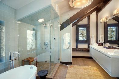 Ejemplo de cuarto de baño principal contemporáneo con bañera exenta, ducha esquinera, baldosas y/o azulejos grises, baldosas y/o azulejos de vidrio, lavabo integrado, ducha con puerta con bisagras y espejo con luz
