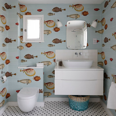 Inspiration for a mid-sized coastal kids' white tile and subway tile ceramic tile bathroom remodel in London with flat-panel cabinets, white cabinets, quartzite countertops, multicolored walls, a vessel sink and a one-piece toilet