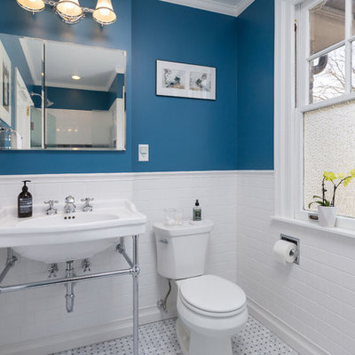 Mid-sized elegant 3/4 white tile and subway tile white floor alcove shower photo in Philadelphia with blue walls, a two-piece toilet, a wall-mount sink and a hinged shower door
