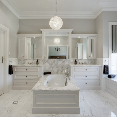 Example of a large classic master gray tile and stone slab marble floor bathroom design in Perth with marble countertops, an undermount tub, an undermount sink, recessed-panel cabinets, white cabinets, gray walls and gray countertops