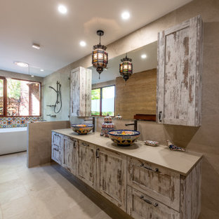Photo of a large mediterranean master wet room bathroom in Perth with shaker cabinets, a freestanding tub, beige tile, porcelain tile, porcelain floors, a vessel sink, beige floor, an open shower, grey benchtops, a double vanity, a floating vanity and distressed cabinets.