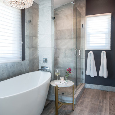 Inspiration for a mid-sized transitional master gray tile and marble tile porcelain tile and gray floor bathroom remodel in Denver with a hinged shower door, black walls, marble countertops and gray countertops