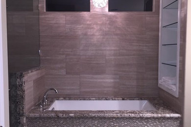 Inspiration for a mid-sized transitional master beige tile and porcelain tile porcelain tile and beige floor doorless shower remodel in Jacksonville with raised-panel cabinets, dark wood cabinets, an undermount tub, a one-piece toilet, beige walls, a drop-in sink, granite countertops and a hinged shower door