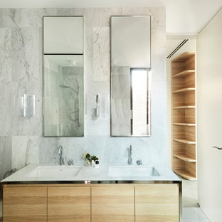 This is an example of a modern master bathroom in Sydney with flat-panel cabinets, medium wood cabinets, white tile, white walls, an undermount sink, white floor and white benchtops.