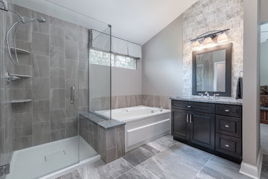 Inspiration for a mid-sized transitional master multicolored tile and porcelain tile porcelain tile and gray floor corner shower remodel in Chicago with shaker cabinets, dark wood cabinets, gray walls, an undermount sink, granite countertops, a hinged shower door and multicolored countertops