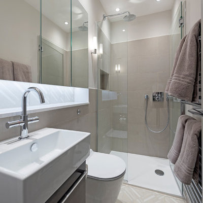 Example of a small ornate master beige tile and porcelain tile porcelain tile and multicolored floor walk-in shower design in London with flat-panel cabinets, a wall-mount toilet, white walls, a wall-mount sink, quartz countertops and a hinged shower door