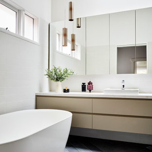 This is an example of a mid-sized contemporary master bathroom in Melbourne with flat-panel cabinets, beige cabinets, a freestanding tub, white walls, a vessel sink, grey floor, white benchtops, a single vanity and a floating vanity.