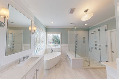 Bathroom - large transitional master white tile and porcelain tile porcelain tile and gray floor bathroom idea in Raleigh with shaker cabinets, white cabinets, a two-piece toilet, blue walls, an undermount sink, quartz countertops, a hinged shower door and white countertops