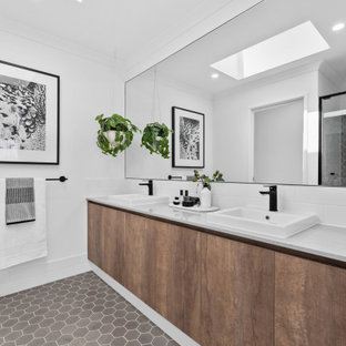 This is an example of a large scandinavian 3/4 bathroom in Perth with flat-panel cabinets, medium wood cabinets, an alcove shower, white walls, a drop-in sink, grey floor, a sliding shower screen and grey benchtops.