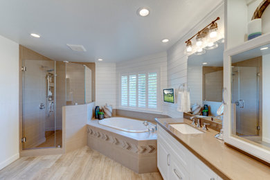 Mid-sized mountain style master brown tile and porcelain tile porcelain tile and brown floor bathroom photo in San Francisco with flat-panel cabinets, white cabinets, a two-piece toilet, white walls, an undermount sink, quartz countertops, a hinged shower door and brown countertops