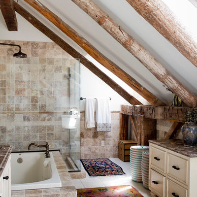 Example of an eclectic beige tile bathroom design in New York with white walls and brown countertops
