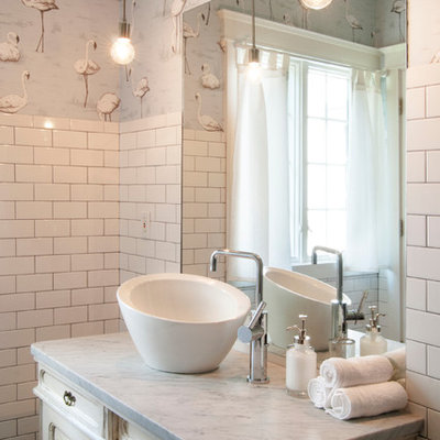 Inspiration for a mid-sized eclectic white tile and subway tile ceramic tile bathroom remodel in Cleveland with a vessel sink, furniture-like cabinets, distressed cabinets, marble countertops and multicolored walls