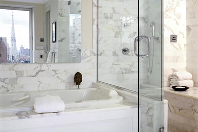 Large trendy master white tile and marble tile mosaic tile floor and white floor bathroom photo in New York with white cabinets, beige walls, marble countertops and a hinged shower door