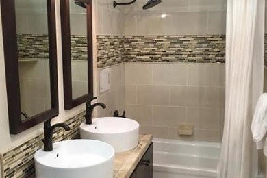Bathroom - small contemporary 3/4 multicolored tile and glass tile limestone floor bathroom idea in Baltimore with flat-panel cabinets, black cabinets, beige walls, a vessel sink and tile countertops