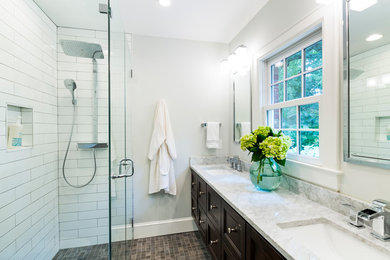 Mid-sized transitional master white tile and subway tile slate floor and multicolored floor walk-in shower photo in Charlotte with recessed-panel cabinets, dark wood cabinets, gray walls, an undermount sink, a hinged shower door, marble countertops and a wall-mount toilet