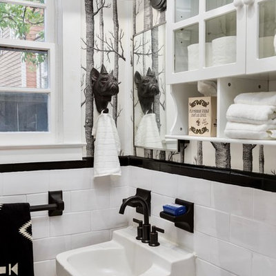 Example of an eclectic bathroom design in Atlanta with glass-front cabinets, yellow cabinets, multicolored walls and a wall-mount sink