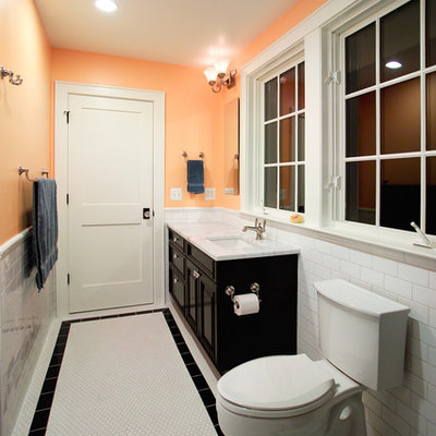 Bathroom - traditional white tile and subway tile white floor bathroom idea in DC Metro with an undermount sink, raised-panel cabinets, black cabinets and a two-piece toilet