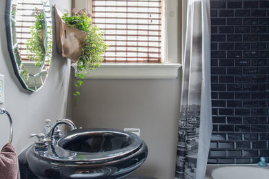 Small trendy 3/4 black tile and subway tile marble floor tub/shower combo photo in New Orleans with an undermount tub, a pedestal sink, a two-piece toilet and gray walls