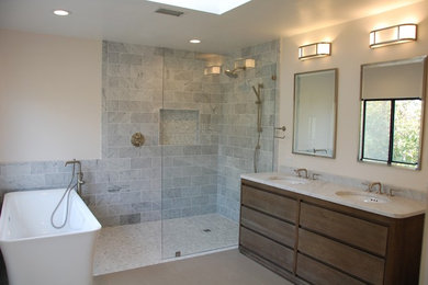 Inspiration for a mid-sized contemporary master gray tile and marble tile bathroom remodel in San Diego with flat-panel cabinets, dark wood cabinets, beige walls, an undermount sink, granite countertops and gray countertops