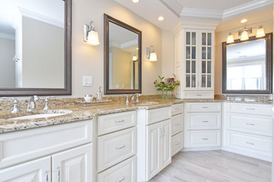 Inspiration for a large transitional master gray tile and porcelain tile porcelain tile and gray floor drop-in bathtub remodel in Providence with raised-panel cabinets, white cabinets, beige walls, an undermount sink, granite countertops and multicolored countertops