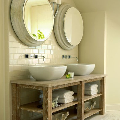Example of a classic beige tile and subway tile bathroom design in Nashville with a vessel sink, open cabinets, wood countertops and beige countertops