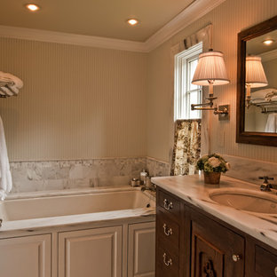 Inspiration for a large transitional master bathroom in Nashville with an undermount sink, furniture-like cabinets, medium wood cabinets, onyx benchtops, a japanese tub, a one-piece toilet, white tile, mosaic tile, white walls and ceramic floors.