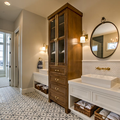 Inspiration for a large cottage master white tile and ceramic tile multicolored floor and cement tile floor bathroom remodel in Omaha with recessed-panel cabinets, white cabinets, gray walls, a vessel sink and white countertops