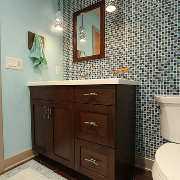Nautical Basement Bathroom with Square Glass Tile Wall and Dark Stained Maple Ca