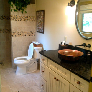 Doorless shower - mid-sized country 3/4 beige tile and ceramic tile ceramic tile doorless shower idea in Philadelphia with shaker cabinets, white cabinets, beige walls, a vessel sink and solid surface countertops