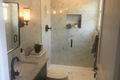 Inspiration for a small contemporary white tile and marble tile marble floor, white floor and single-sink walk-in shower remodel in Portland with shaker cabinets, black cabinets, a two-piece toilet, white walls, an undermount sink, marble countertops, a hinged shower door, white countertops, a niche and a freestanding vanity