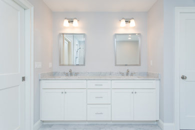 Inspiration for a large timeless master marble tile marble floor, gray floor and double-sink bathroom remodel in Boston with shaker cabinets, white cabinets, gray walls, an undermount sink, marble countertops, gray countertops and a built-in vanity