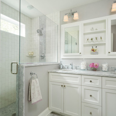 Inspiration for a mid-sized transitional master stone tile and white tile mosaic tile floor alcove shower remodel in Minneapolis with an undermount sink, shaker cabinets, white cabinets, gray walls and marble countertops