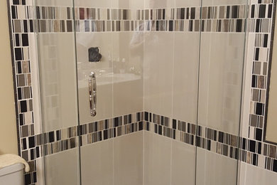 Example of a mid-sized transitional 3/4 mosaic tile floor corner shower design in Minneapolis with a two-piece toilet and beige walls