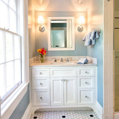 Alcove shower - traditional mosaic tile and white tile porcelain tile and white floor alcove shower idea in New York with recessed-panel cabinets, white cabinets, blue walls, an undermount sink, marble countertops, a hinged shower door and gray countertops