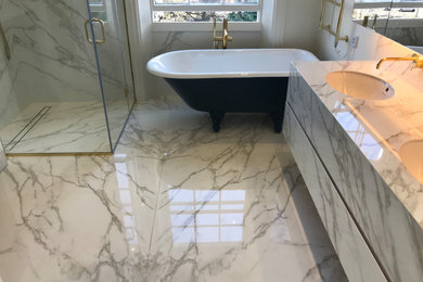 Inspiration for a medium sized modern family bathroom in London with white cabinets, a freestanding bath, a corner shower, porcelain flooring, engineered stone worktops, white floors, a hinged door and white worktops.