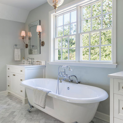 Large elegant master white tile and stone tile marble floor bathroom photo in Minneapolis with recessed-panel cabinets, white cabinets, quartz countertops, gray walls and a console sink