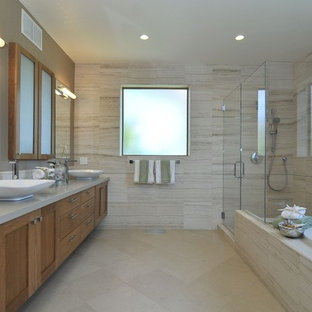 Design ideas for a transitional bathroom in San Francisco with a vessel sink, medium wood cabinets, engineered quartz benchtops, a drop-in tub, a corner shower, beige tile, beige walls, ceramic floors, shaker cabinets and travertine.
