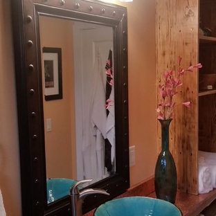 Design ideas for a small arts and crafts master bathroom in Other with a vessel sink, furniture-like cabinets, distressed cabinets, copper benchtops, an alcove tub, a shower/bathtub combo, a two-piece toilet, multi-coloured tile, stone tile and slate floors.
