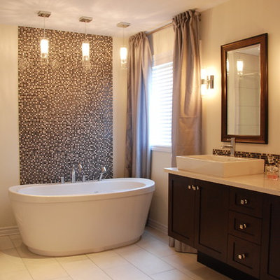 Example of a trendy mosaic tile freestanding bathtub design in Montreal with a vessel sink