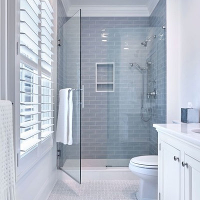 Mid-sized elegant kids' blue tile and ceramic tile marble floor and white floor alcove shower photo in New York with recessed-panel cabinets, white cabinets, a two-piece toilet, white walls, an undermount sink, marble countertops and a hinged shower door