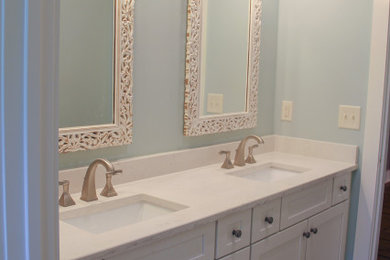 Foto de cuarto de baño doble tradicional con puertas de armario blancas, encimera de cuarzo compacto y encimeras blancas