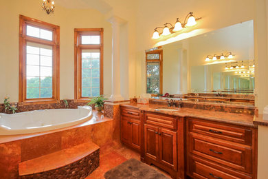 Bathroom - large traditional master red tile and pebble tile travertine floor bathroom idea in DC Metro with an undermount sink, raised-panel cabinets, dark wood cabinets, granite countertops, a one-piece toilet and yellow walls