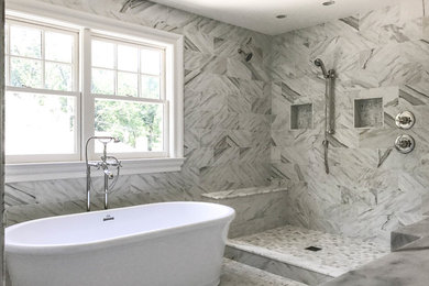 Elegant freestanding bathtub photo in Seattle with beige walls