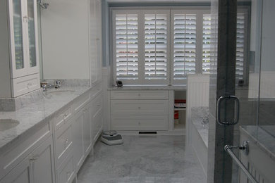 Example of a mid-sized classic master white tile and stone tile marble floor corner shower design in DC Metro with an undermount sink, flat-panel cabinets, white cabinets, marble countertops, an undermount tub, a one-piece toilet and blue walls