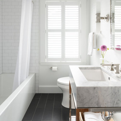 Transitional 3/4 white tile gray floor alcove bathtub photo in Boston with white walls, an undermount sink and gray countertops