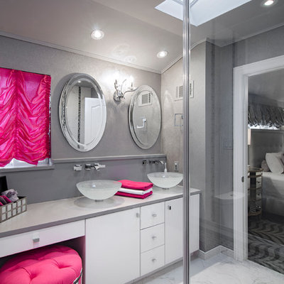Corner shower - mid-sized contemporary master gray tile, white tile and stone tile marble floor and white floor corner shower idea in New York with a vessel sink, flat-panel cabinets, white cabinets, gray walls, solid surface countertops, a hinged shower door and gray countertops